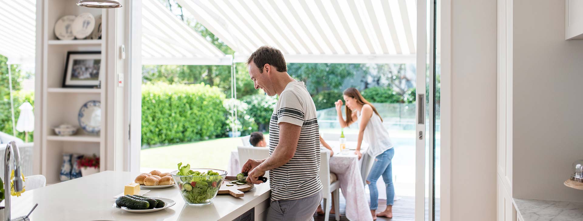 Man preparing food for family in spacious open-plan kitchen